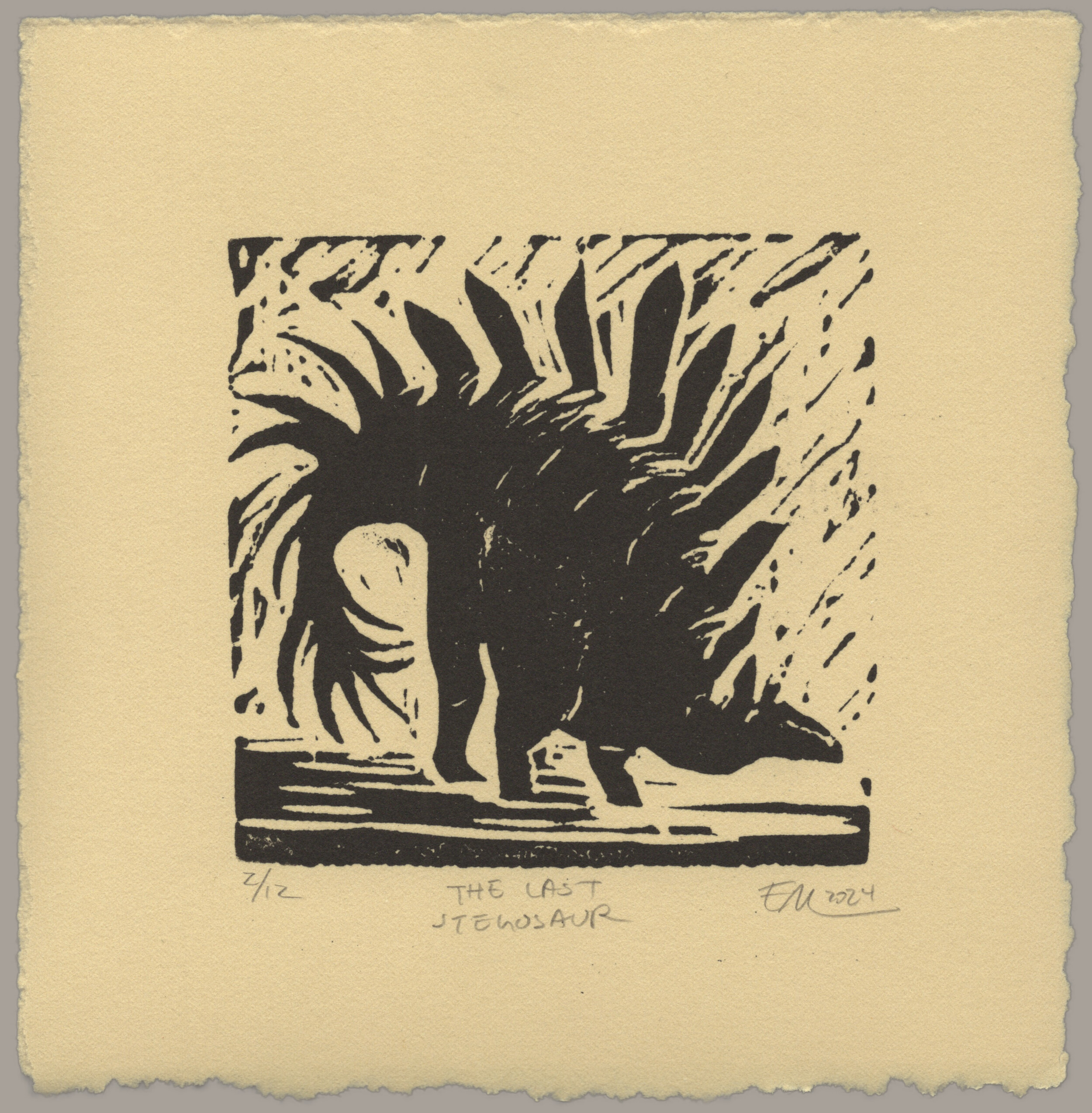 A black linocut print on warm, sand-colored paper showing a large dinosaur with tall plates petruding from its back. Its head is low to the ground and its back is arched. Its spiked tail curves back towards the ground in a defensive pose. The print is signed '2 of 12, The Last Stegosaur, EM 2024'
