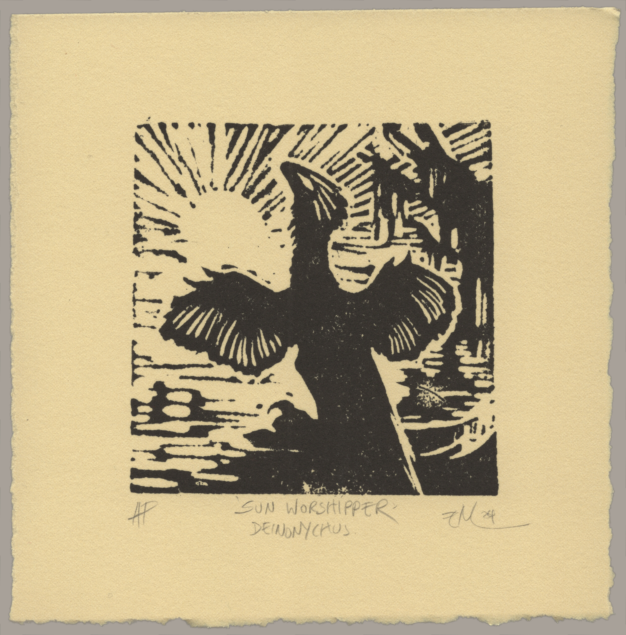 A black linocut print on warm paper showing a feathered dinosaur opening its wings in front of the rising sun. The print is signed 'AP, Sun Worshipper (Deinonychus), EM 24'